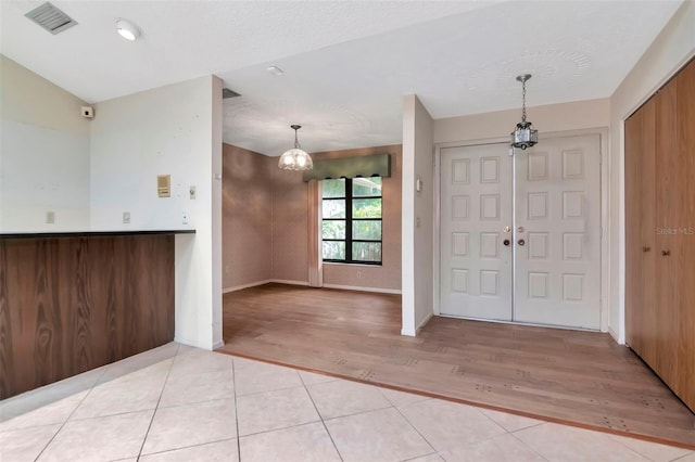 5101 Estates Cir, Sarasota, FL 34243 - entrance foyer with a chandelier and light wood-type flooring