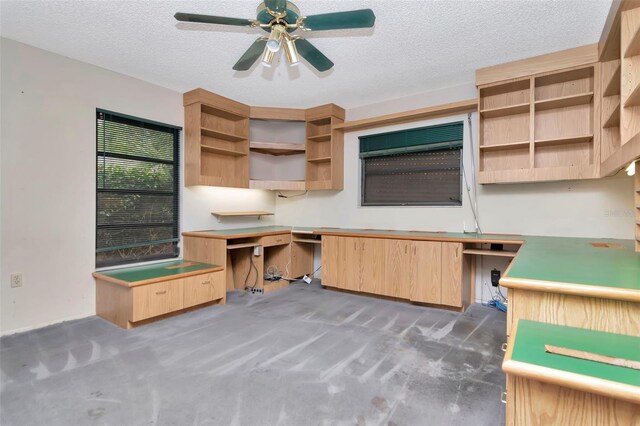 5101 Estates Cir, Sarasota, FL 34243 - unfurnished office with carpet flooring, a textured ceiling, a ceiling fan, and built in study area