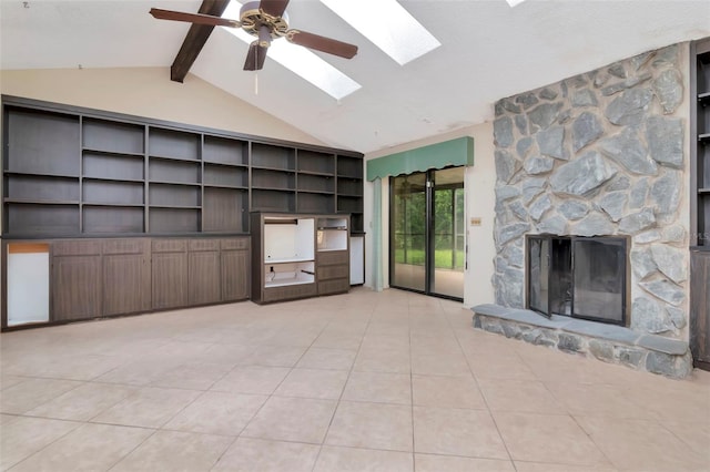 5101 Estates Cir, Sarasota, FL 34243 - unfurnished living room featuring a skylight, light tile patterned floors, a fireplace, and a ceiling fan