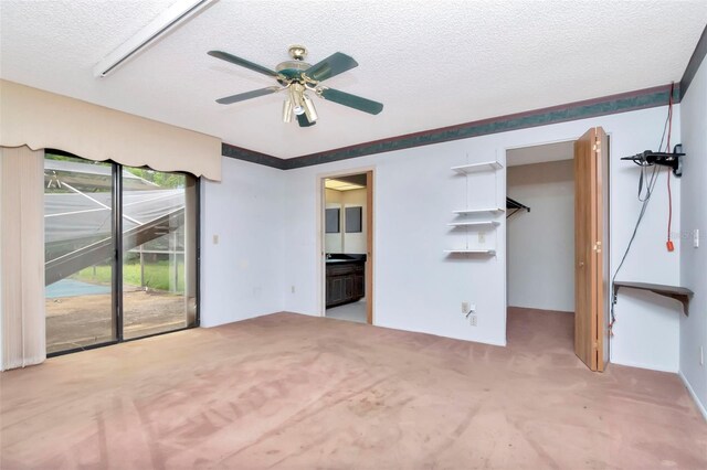 5101 Estates Cir, Sarasota, FL 34243 - spare room featuring a textured ceiling, carpet, and a ceiling fan