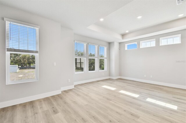 4717 W Mccoy St Unit 9, Tampa, FL 33616 - unfurnished room with light wood-style flooring, recessed lighting, baseboards, and a raised ceiling
