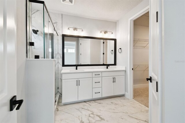 4717 W Mccoy St Unit 9, Tampa, FL 33616 - bathroom featuring a stall shower, double vanity, a walk in closet, and marble finish floors