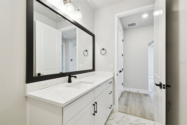 4717 W Mccoy St Unit 9, Tampa, FL 33616 - bathroom with marble finish floors, vanity, and baseboards