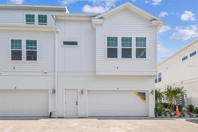 4717 W Mccoy St Unit 9, Tampa, FL 33616 - view of front of property featuring an attached garage and driveway