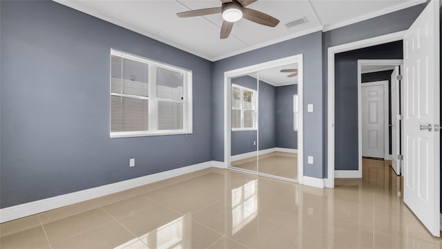 unfurnished bedroom with light tile patterned floors, a closet, visible vents, ceiling fan, and baseboards