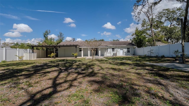 back of house with a lawn, a patio area, and a fenced backyard