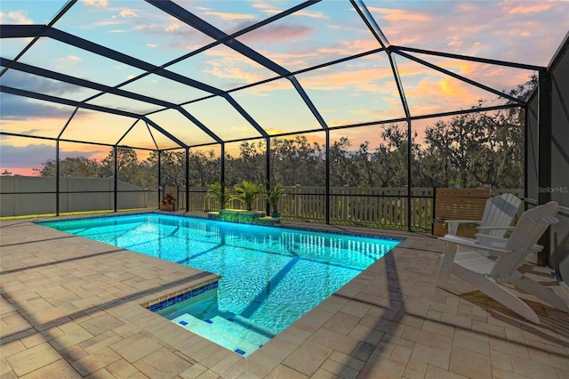 view of pool featuring a patio, glass enclosure, fence, and a fenced in pool