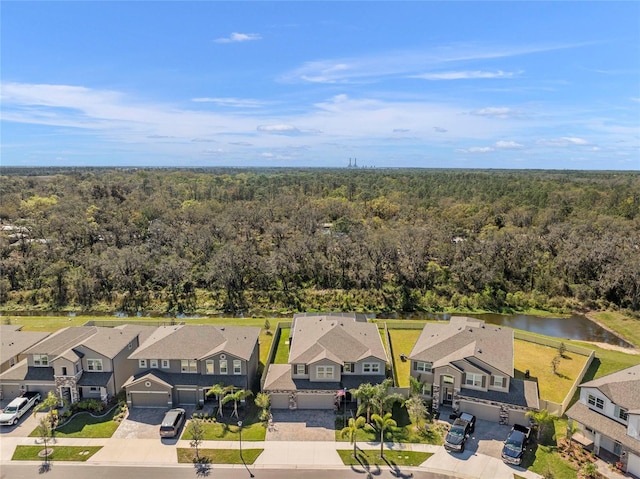 bird's eye view with a forest view, a water view, and a residential view