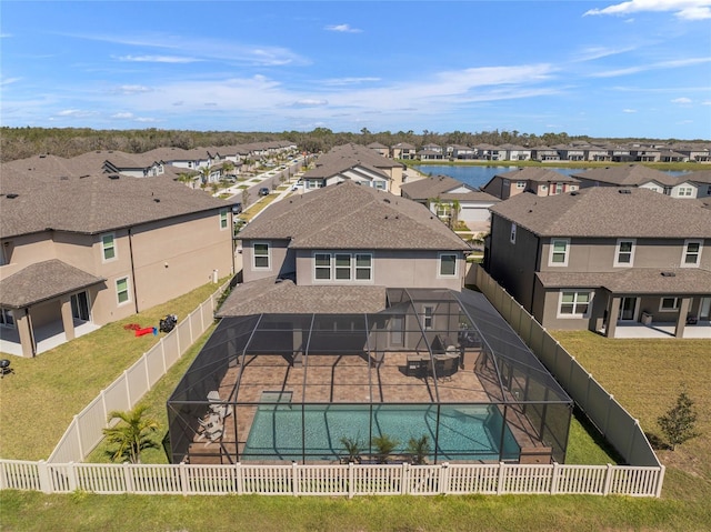 view of swimming pool featuring a residential view, glass enclosure, a fenced backyard, and a patio area