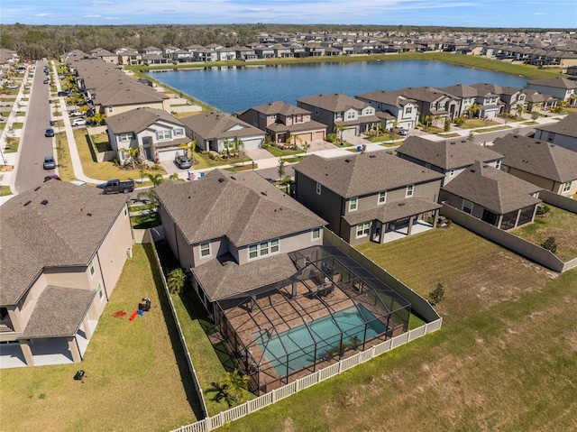 drone / aerial view with a water view and a residential view