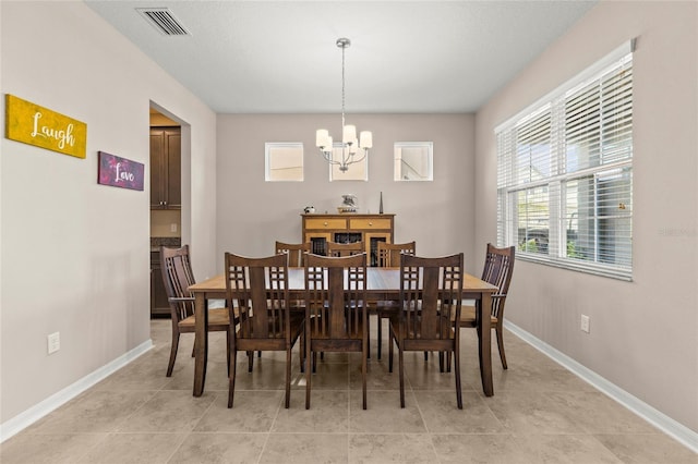 dining room with visible vents, a notable chandelier, baseboards, and light tile patterned flooring