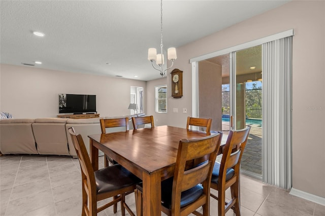 dining room featuring a healthy amount of sunlight, an inviting chandelier, light tile patterned floors, and recessed lighting