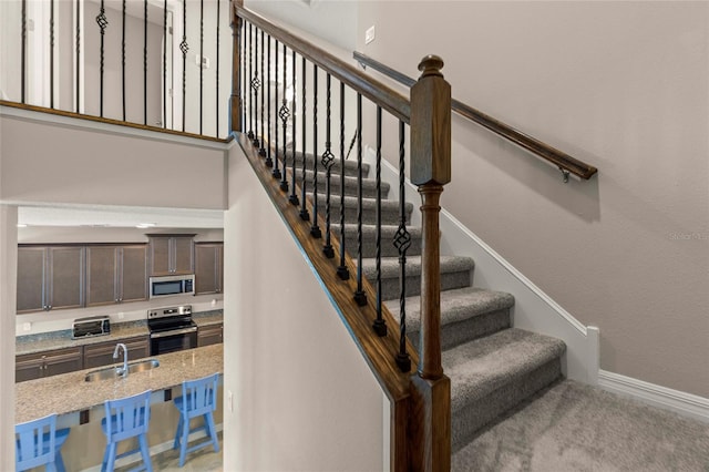 stairway featuring baseboards