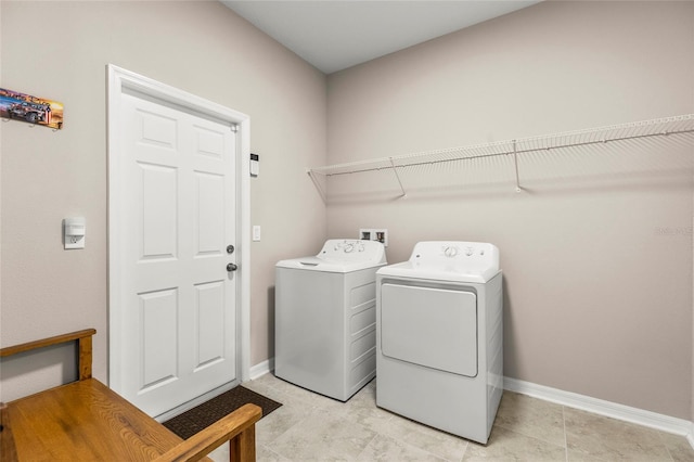 laundry area featuring baseboards, laundry area, and washer and dryer