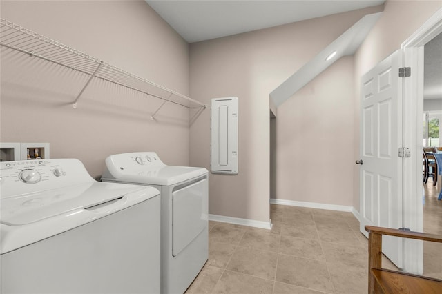 clothes washing area with laundry area, light tile patterned floors, electric panel, baseboards, and washer and clothes dryer