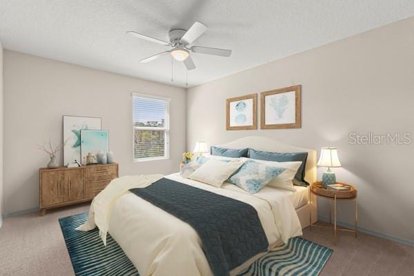 carpeted bedroom with ceiling fan and baseboards