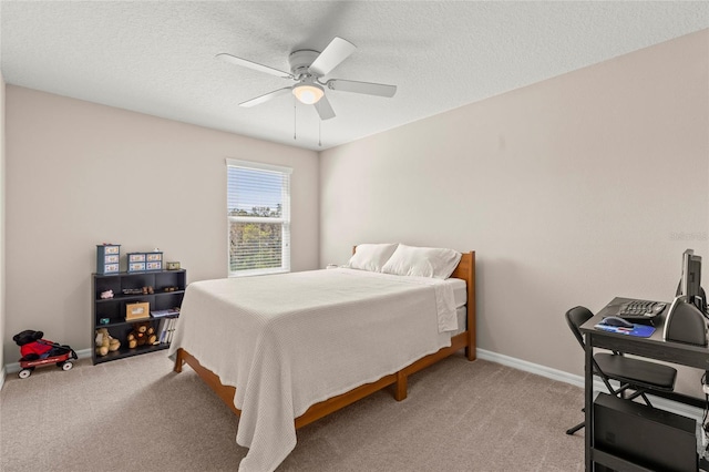 bedroom with light carpet, a textured ceiling, and baseboards