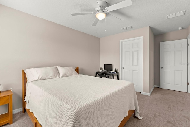 bedroom featuring baseboards, visible vents, ceiling fan, and light colored carpet