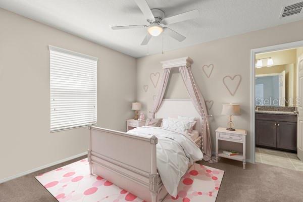 bedroom with a ceiling fan, light colored carpet, visible vents, and connected bathroom