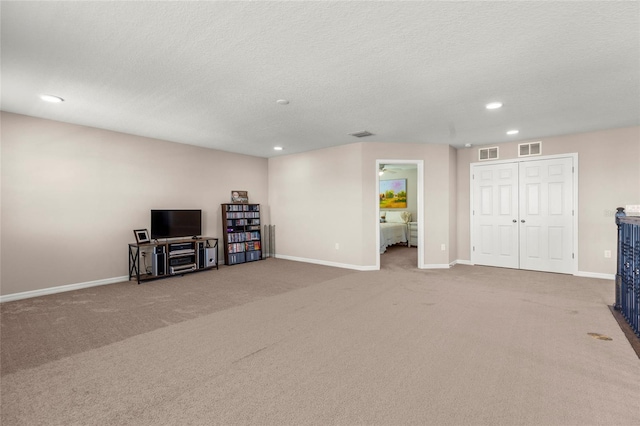 interior space featuring baseboards, visible vents, and carpet flooring