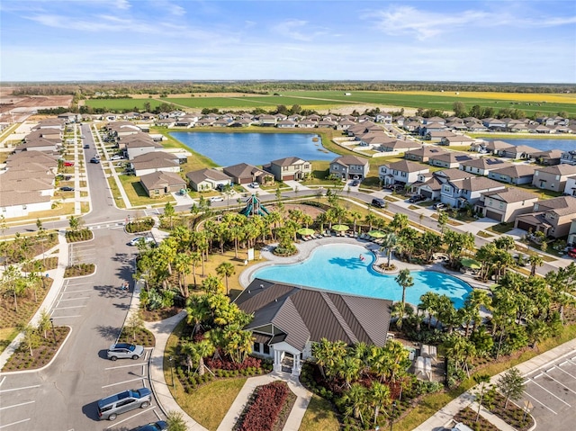 drone / aerial view with a water view and a residential view