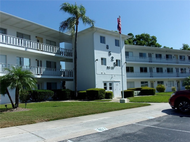 view of property featuring uncovered parking