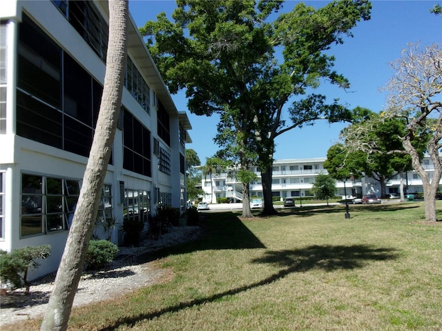 view of property's community featuring a residential view and a lawn