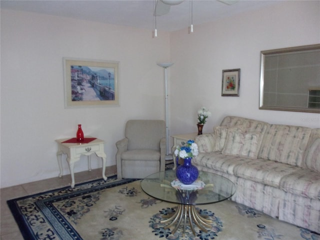 tiled living area with ceiling fan