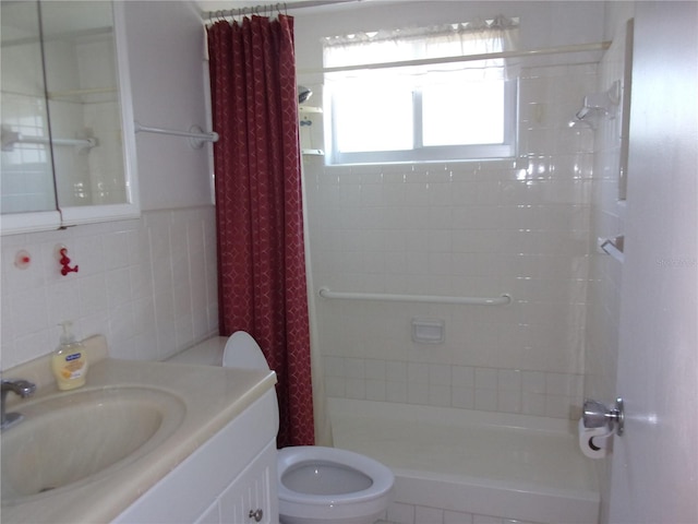 bathroom with toilet, a shower stall, tile walls, and vanity