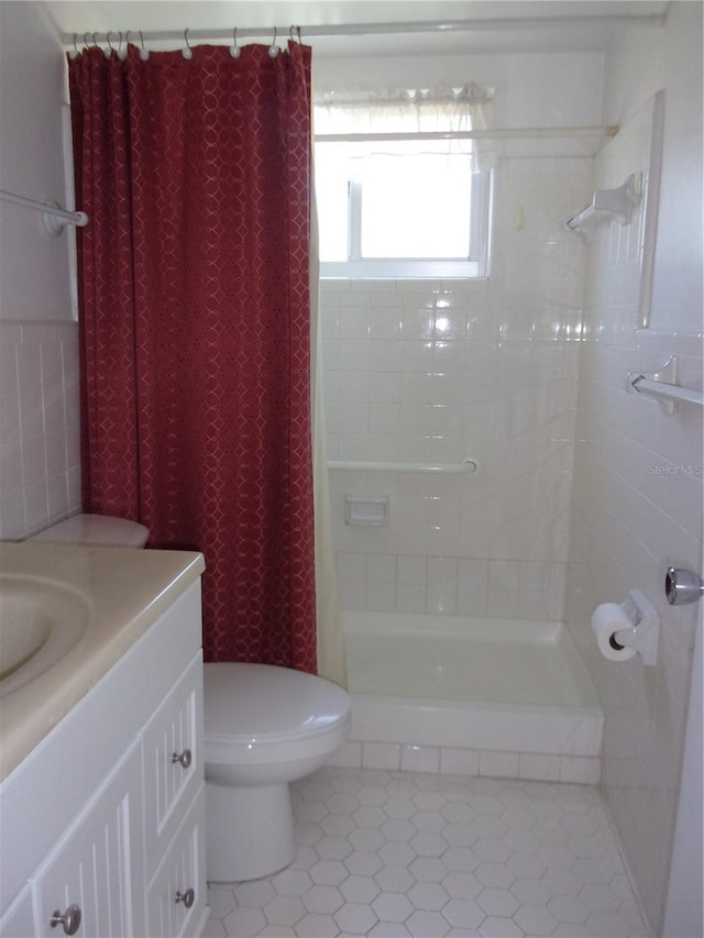 full bathroom featuring a stall shower, vanity, toilet, and tile patterned floors