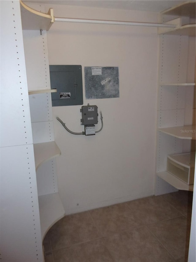 spacious closet with electric panel and tile patterned floors