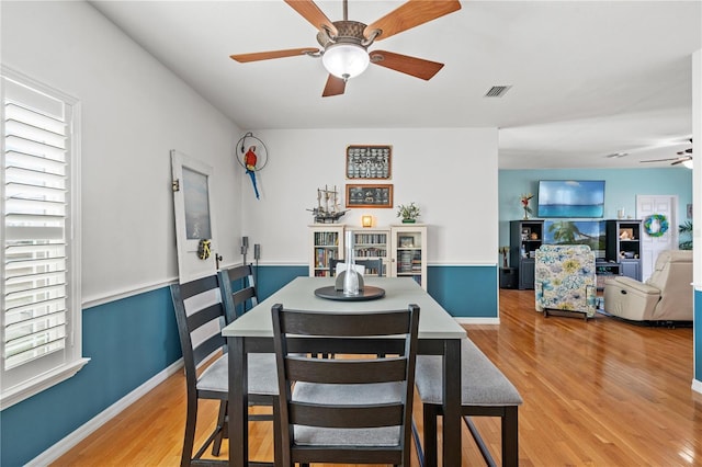 dining area featuring visible vents, baseboards, light wood-style flooring, and a ceiling fan