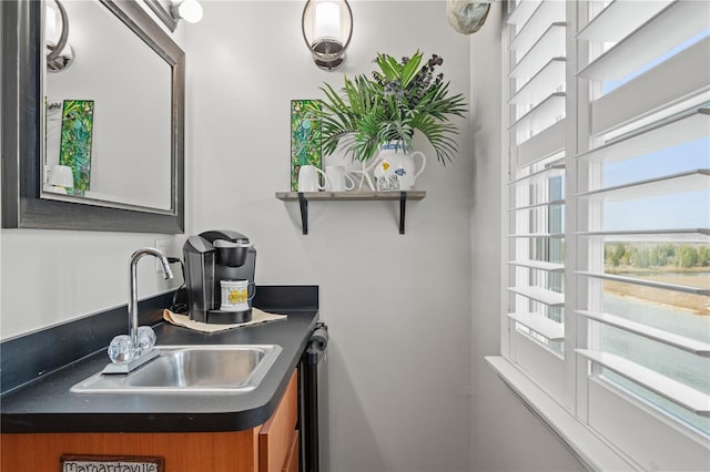 kitchen with dark countertops, brown cabinetry, and a sink