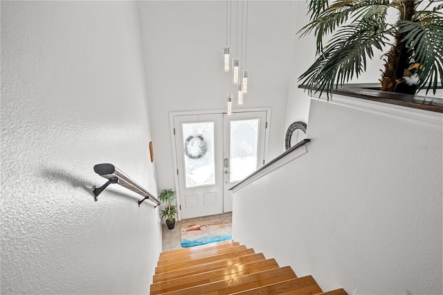 foyer with stairway and french doors