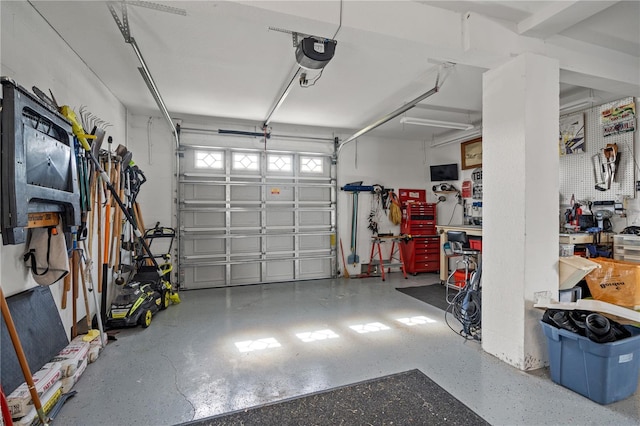 garage featuring a garage door opener and a workshop area