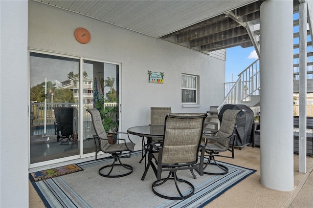 view of patio / terrace with outdoor dining area and stairs