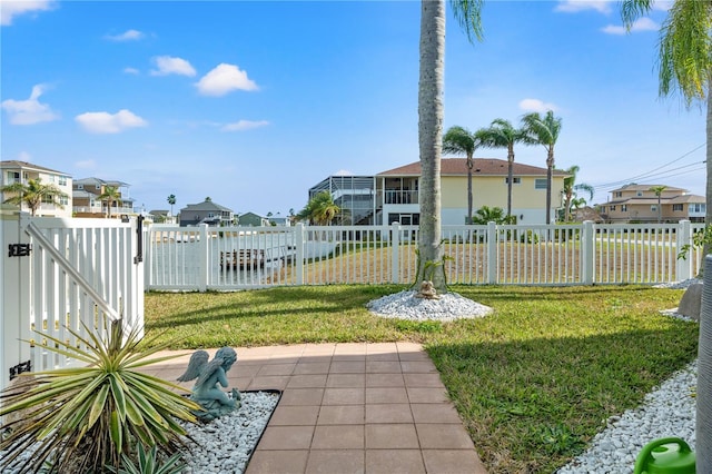 view of yard with a residential view, fence, and a gate