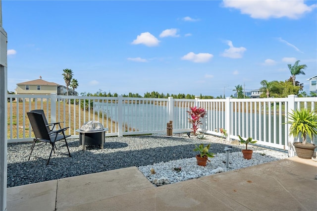 view of patio with an outdoor fire pit and fence