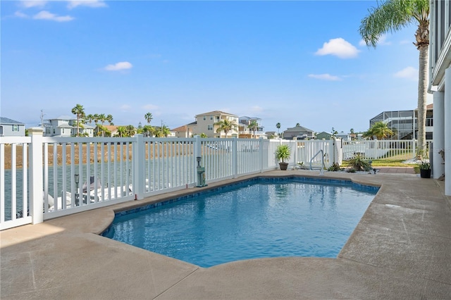view of swimming pool with a residential view, a fenced in pool, a fenced backyard, and a patio area