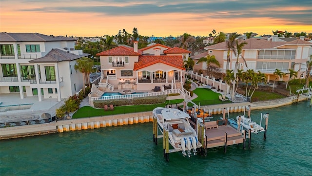 rear view of house with a residential view, a water view, and boat lift