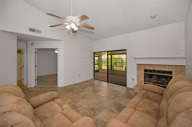 2446 Bentley Dr, Palm Harbor, FL 34684 - living area with lofted ceiling, ceiling fan, visible vents, and a tile fireplace