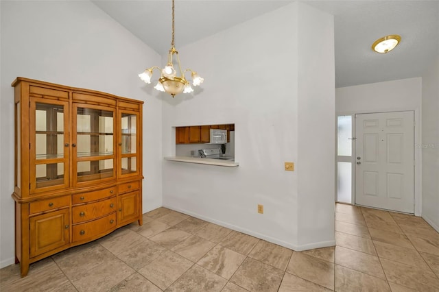 2446 Bentley Dr, Palm Harbor, FL 34684 - dining area featuring baseboards, light tile patterned floors, vaulted ceiling, and a notable chandelier