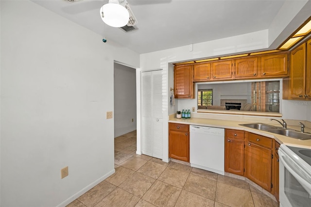 2446 Bentley Dr, Palm Harbor, FL 34684 - kitchen with white appliances, light countertops, a sink, and brown cabinetry