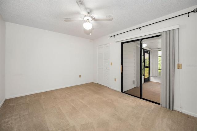 2446 Bentley Dr, Palm Harbor, FL 34684 - unfurnished bedroom with baseboards, a ceiling fan, carpet, and a textured ceiling
