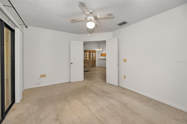 2446 Bentley Dr, Palm Harbor, FL 34684 - unfurnished bedroom with light carpet, baseboards, visible vents, and a textured ceiling