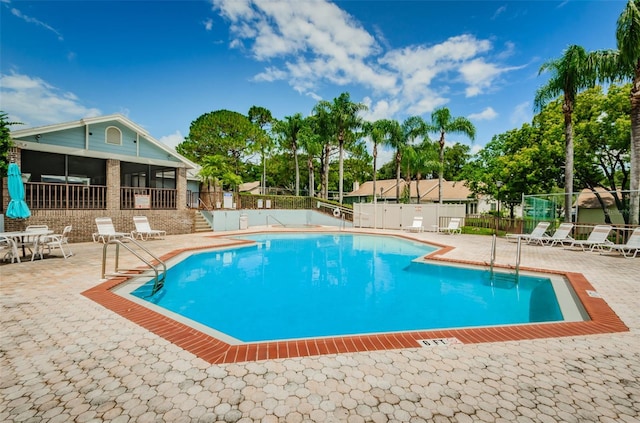 2446 Bentley Dr, Palm Harbor, FL 34684 - community pool featuring a sunroom, fence, and a patio