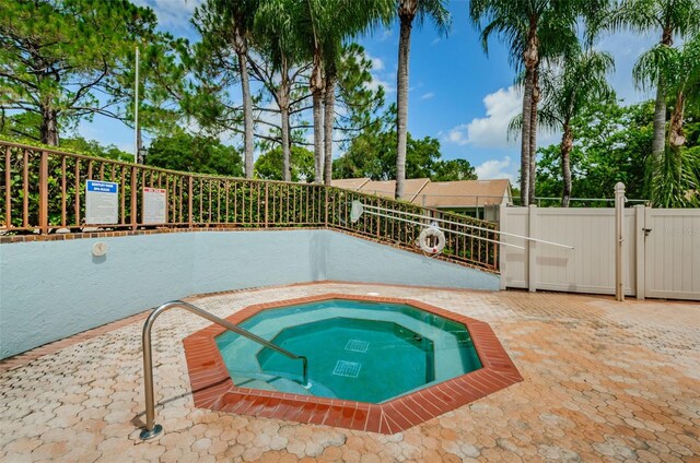 2446 Bentley Dr, Palm Harbor, FL 34684 - view of pool featuring a gate, fence, and a community hot tub