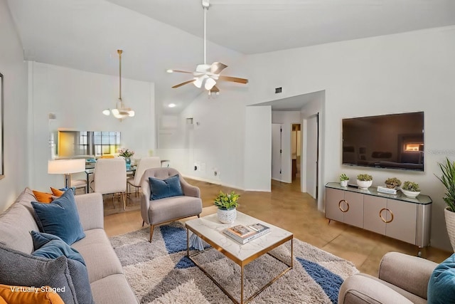 2446 Bentley Dr, Palm Harbor, FL 34684 - living room featuring ceiling fan with notable chandelier and high vaulted ceiling