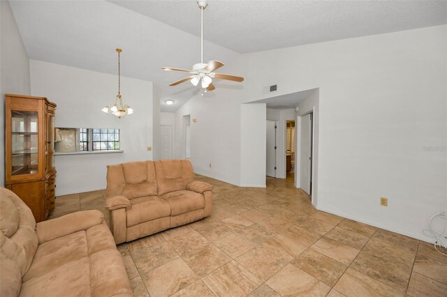 2446 Bentley Dr, Palm Harbor, FL 34684 - living area with ceiling fan with notable chandelier, lofted ceiling, a textured ceiling, and visible vents