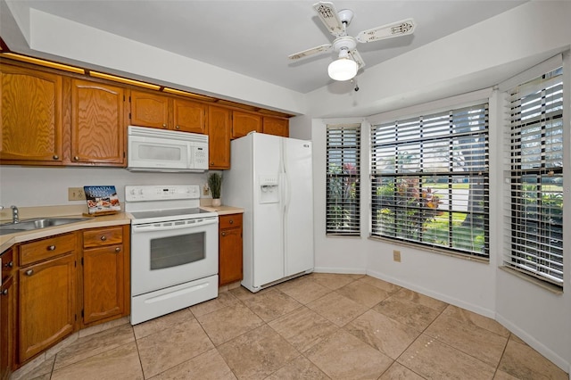 2446 Bentley Dr, Palm Harbor, FL 34684 - kitchen with white appliances, brown cabinetry, light countertops, and a sink